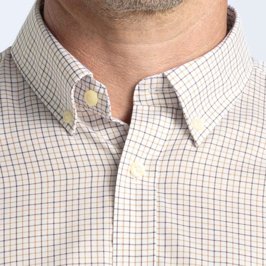 A button-up shirt featuring a check pattern in beige and navy, with a button-down collar. It has a logo on the chest.
