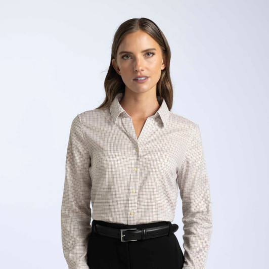 A button-up women's shirt in a light check pattern, featuring a collar and long sleeves. It has a logo.