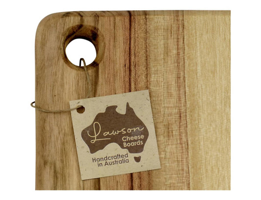 A wooden cheese board with a hole for hanging, featuring natural wood tones and a tag with branding.