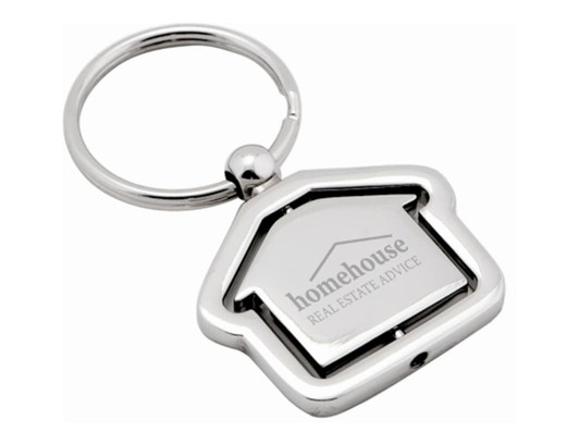 A silver keyring shaped like a house, featuring a logo on the front and a circular keyring attachment.