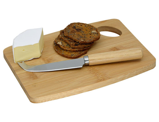 A bamboo cheese board featuring a cheese wedge, crispbread, and a cheese knife with a wooden handle.