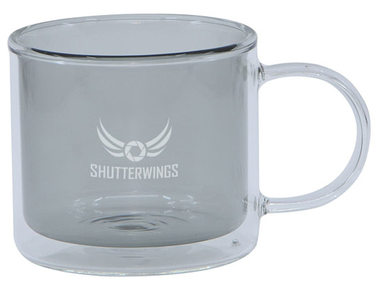 A transparent double wall mug with a grey tint and a handle, featuring a logo on the front.
