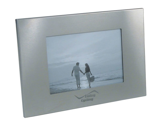 A silver photo frame with a rectangular shape, featuring a central opening for a photo and a logo on the bottom.