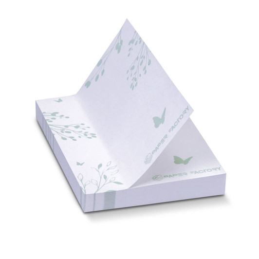 A stack of white recycled sticky pads, featuring delicate leaf and butterfly designs in soft green, with a branding logo.