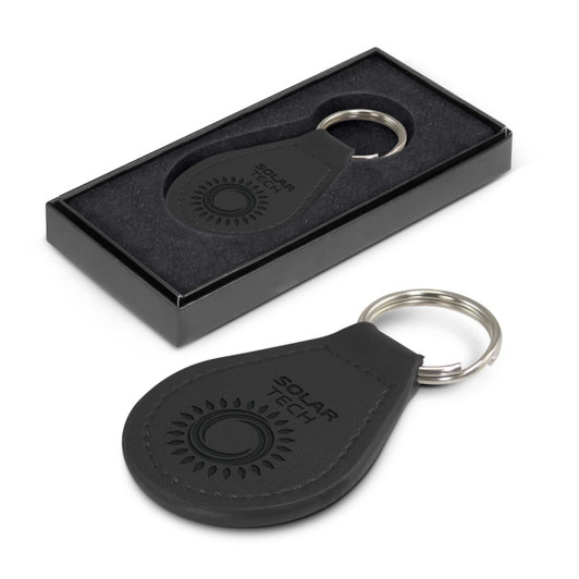 A round black leather key ring with a metal keychain, presented in a sleek black box.