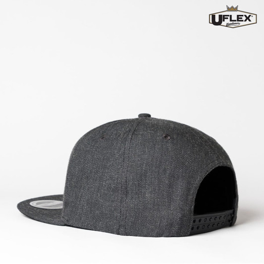 A dark grey snapback cap with a flat brim, featuring a logo on the side.