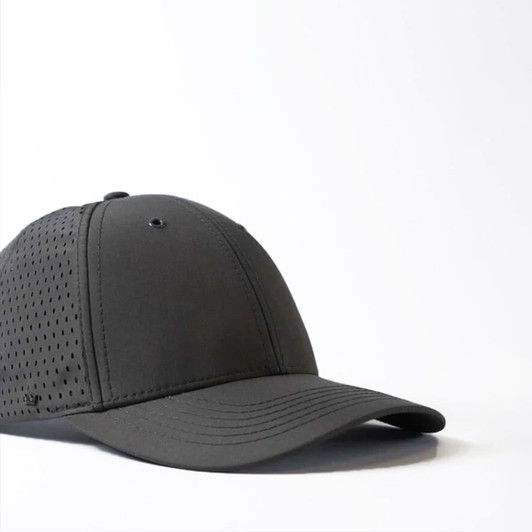 A black snapback cap featuring a curved peak and perforated design, including a logo on the side.