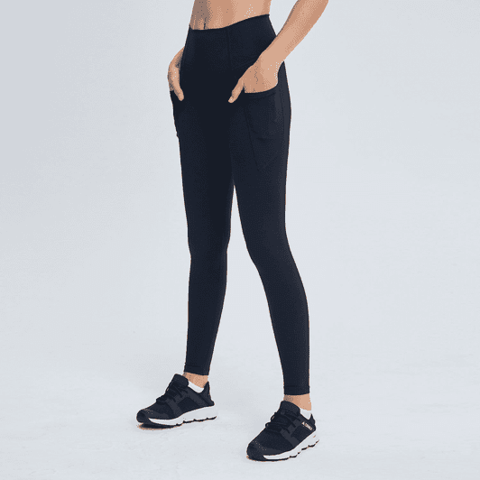 Black high-rise training full tights with pockets, showcased with a pair of black athletic shoes.