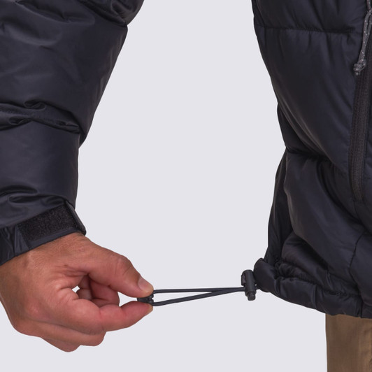 A black puffer jacket with an adjustable drawstring at the hem, featuring a hand pulling the drawstring.