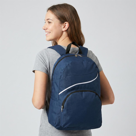 A navy blue backpack with a zippered front pocket and a logo, being worn by a young woman.