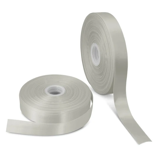 A roll of personalised ribbon in a soft, pale green colour alongside another roll, both on spools.
