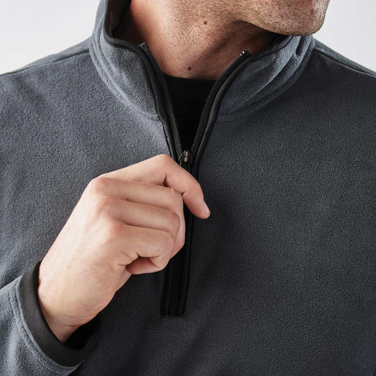 A close-up of a grey men's fleece jumper featuring a 1/4 zip and a discreet logo.