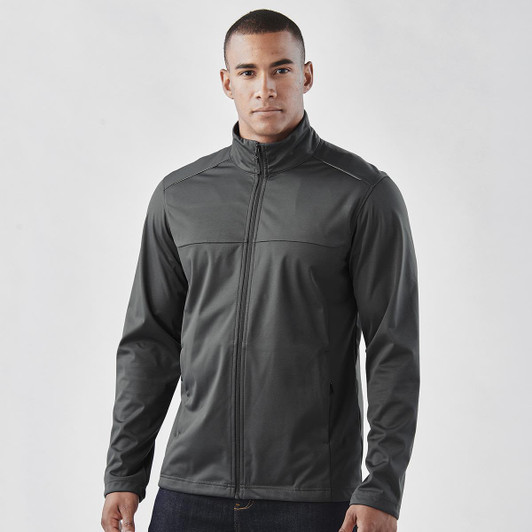 A man wearing a grey lightweight softshell jacket, featuring a zip front and a casual fit. The jacket has a logo.