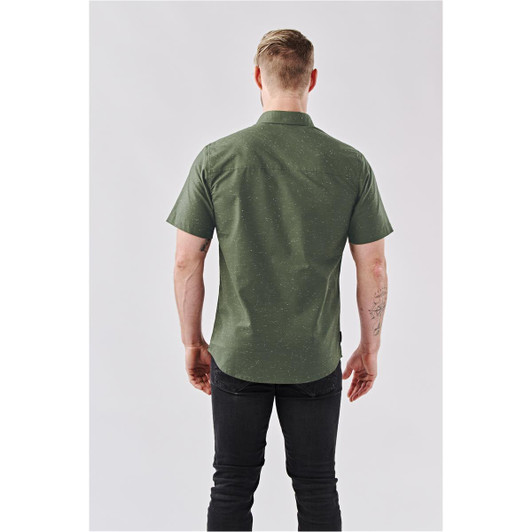 A short-sleeved, dark green button-up shirt with a subtle pattern, featuring a branded logo on the back.