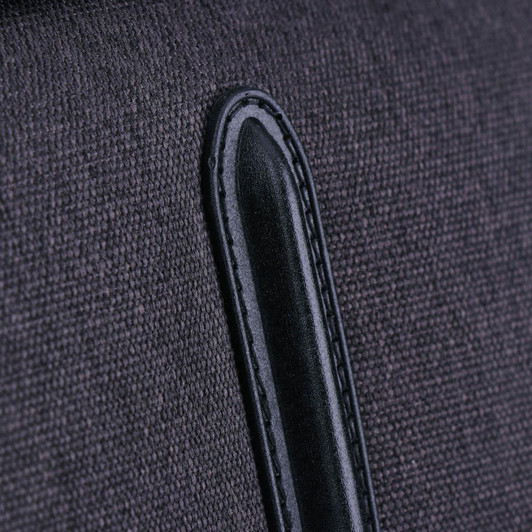 A close-up of a dark grey fabric with a black leather accent, part of the Swissdigital Arosa Duffle Bag.