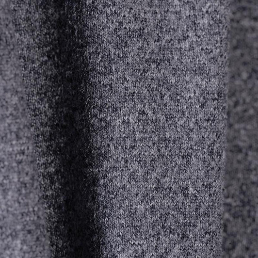 A close-up of a grey textured fabric, showcasing a soft knit material with subtle variations.