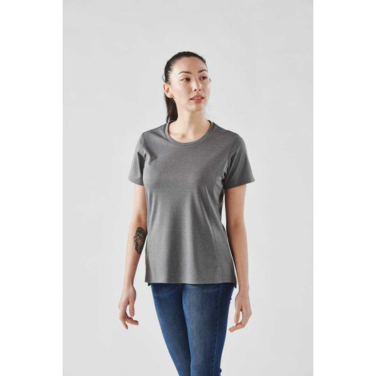 A woman wearing a grey short sleeve performance tee, featuring a rounded neckline and a slightly relaxed fit.