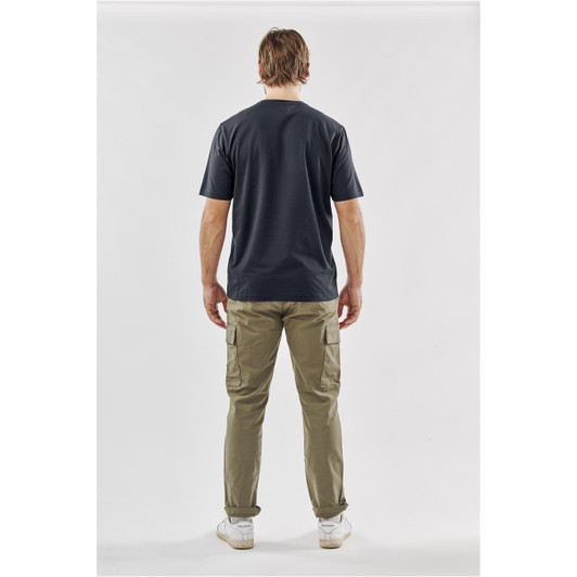 A man is wearing a dark grey T-shirt and khaki cargo pants, viewed from the back. The T-shirt features a logo.