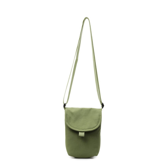 A small size canvas shoulder bag in a muted green colour with an adjustable strap and a flap closure.