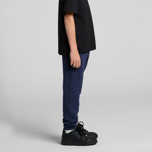 Navy track pants styled with a black t-shirt, featuring a side view and a shoe with a sleek design.
