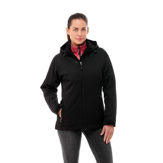 A woman poses in a black insulated softshell jacket with a pink interior, featuring a logo on the sleeve.