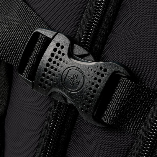 A close-up of a black buckle and strap on a backpack, showcasing its sturdy design and material.