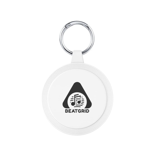 A white keychain with a circular design and a silver keyring, featuring a logo with musical notes.