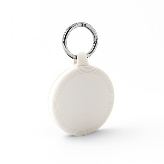 A white keychain with a circular design and a silver metal ring. The keychain features a subtle textured pattern.