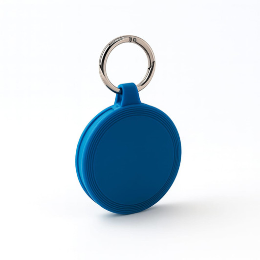 A blue round keychain with a silver ring, featuring a textured design on its surface.