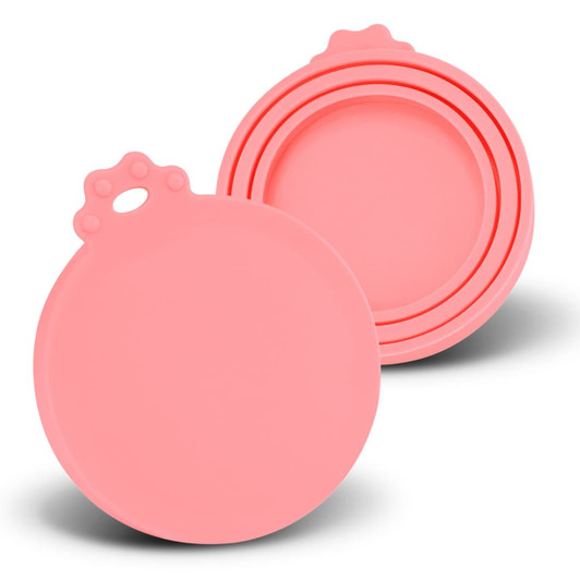 A set of three pink silicone reusable can lids with a round design and a grip handle on top.