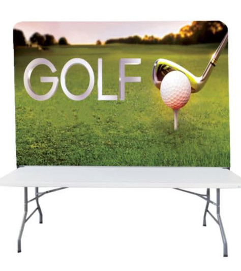 A stretch fabric table top banner stand featuring a golf theme with a large golf tee, ball, and club against a green background.