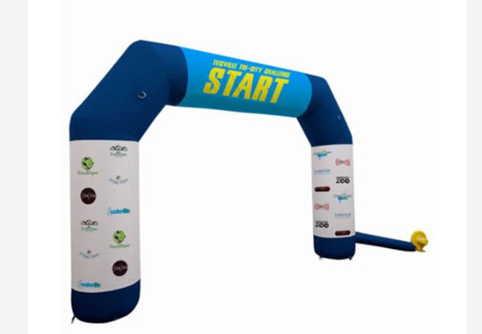 An inflatable air arch in blue and white with a start banner and multiple logos on the sides.