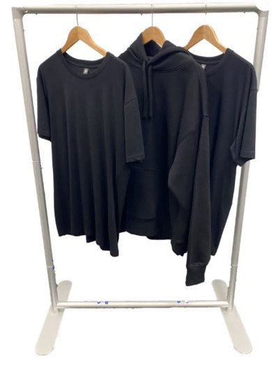 A transportable clothes rack displaying three black garments: a T-shirt, a hoodie, and a short-sleeve shirt.