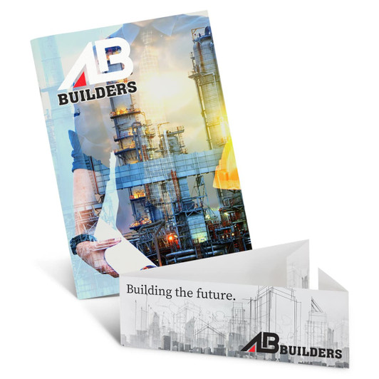 A medium notebook with a vibrant design featuring industrial imagery and a logo. The notebook is opened to display its inside pages.