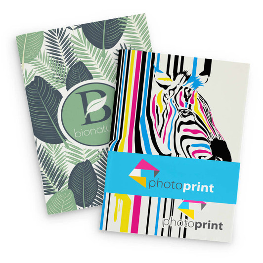A large notebook featuring a leaf-patterned cover and a vibrant zebra design, with branding elements.