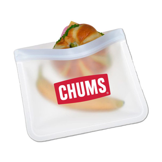 A translucent white PEVA reusable food storage bag with a sandwich and banana inside, featuring a logo.