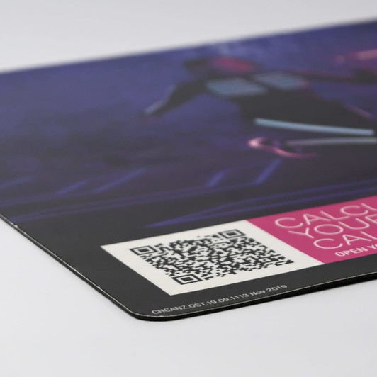 A counter mat featuring a vibrant design with shades of purple and black, displaying a QR code and a logo.