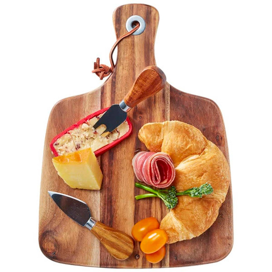 Acacia cheeseboard with knife set, featuring a wooden board, cheese, cured meats, croissant, and cherry tomatoes.