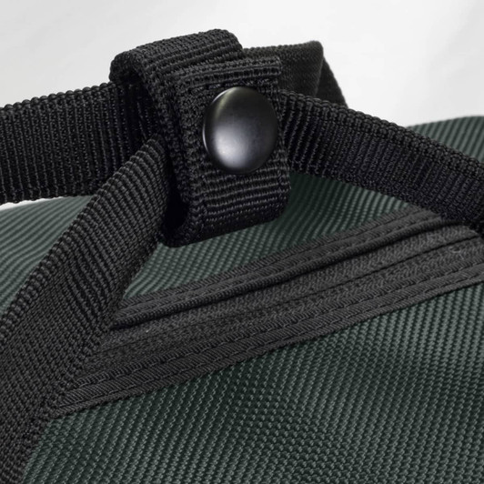 A close-up of a dark green duffle bag showing sturdy black straps and a button fastening. The bag has a textured surface.