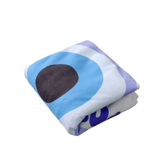 A folded round beach towel featuring blue, purple, and black circular designs, complete with a logo.