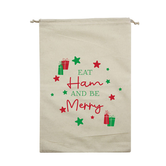 A cream Christmas ham bag featuring festive graphics with green and red gifts and stars, and text in a playful font.