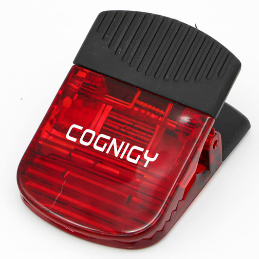 A red wide magnetic Croc clip with a black top, featuring a logo.