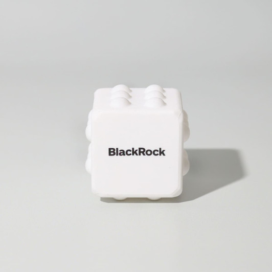 A white cube-shaped toy with raised sections and a logo on one side, designed for fun and games.