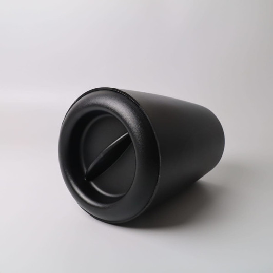 A black ice bucket with a sleek design, featuring a side opening and curved shape. It has a branding logo.