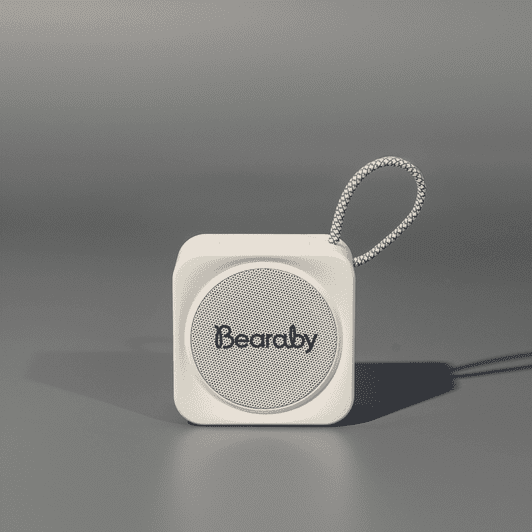 A compact white portable Bluetooth speaker with a loop for attachment. Features a logo on the front.