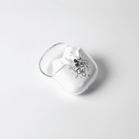 A pair of white noise cancellation earphones in a case featuring a playful design and a logo.