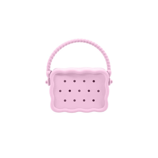 A pink silicone bag with a textured handle and multiple holes for ventilation. It features a rounded, scalloped shape.