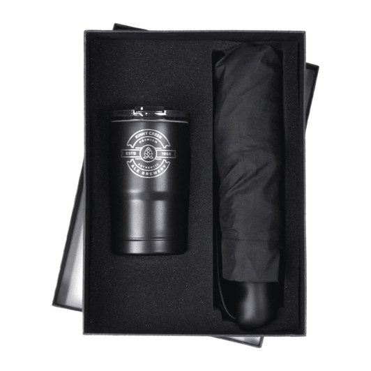 A black tumbler and a black umbrella presented in a gift box with a logo on the tumbler.