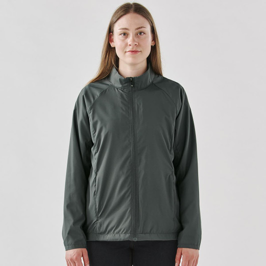 A woman wearing a dark grey full zip rain jacket with a stand collar and a logo on the chest.