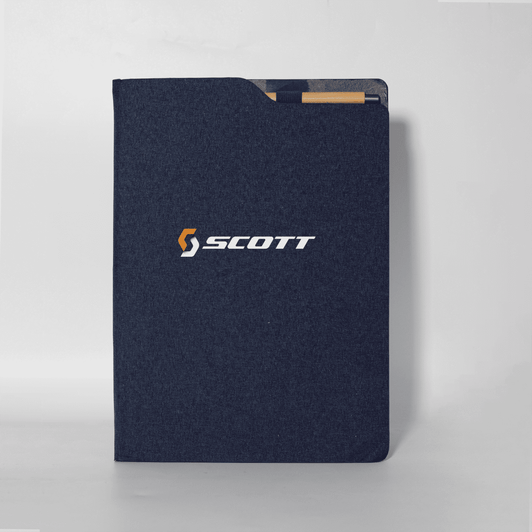 A notebook with a navy blue cover featuring a logo on the front. The design is sleek and minimalist.